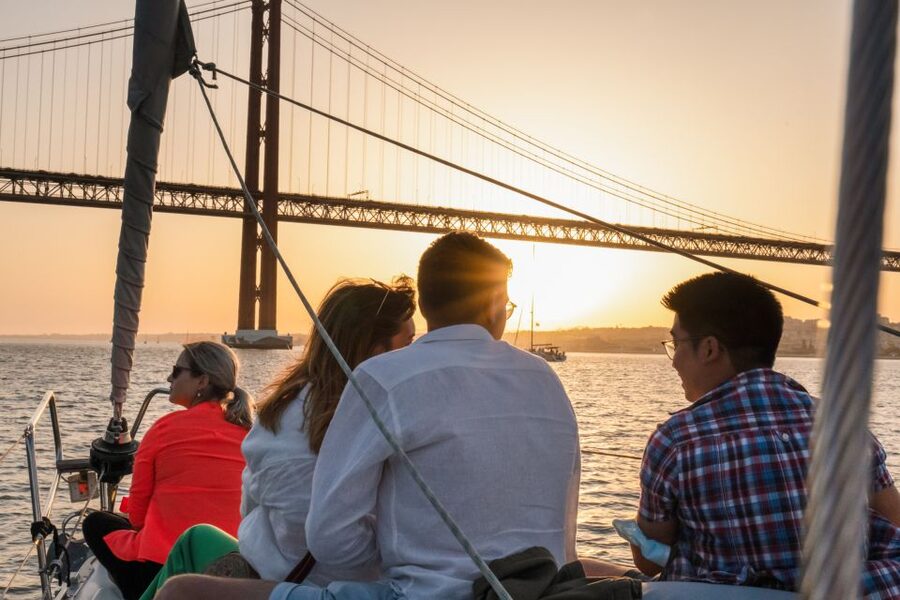 Lisbon: Daytime/Sunset/Night City Sailboat Tour with Drink - Under the 25 de Abril Bridge
