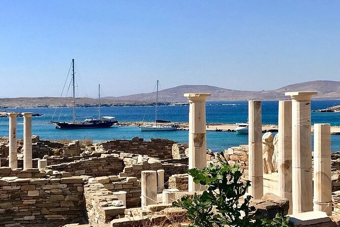 Mykonos Sail Cruise to Rhenia, Guided Tour of Delos, Lunch&Drinks - Rhenia: clear water, a golden beach, and a yacht ladder