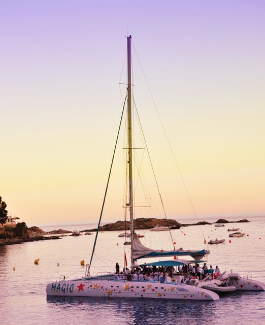 Palma de Mallorca: Sunset Sailing Catamaran Trip with Drink - Leaving Palma harbor as the light softens