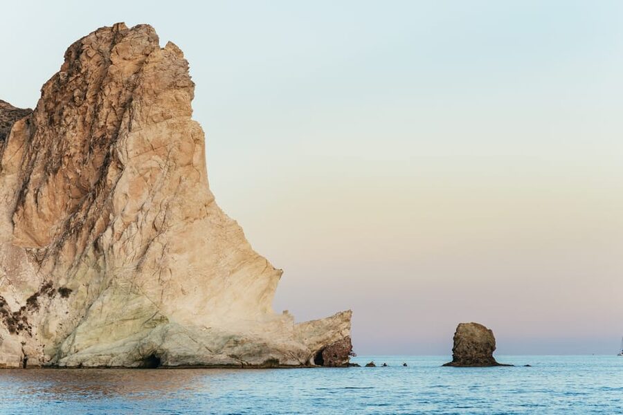 Santorini: Sailing Catamaran Cruise with BBQ and Drinks - The lighthouse and volcanic coast