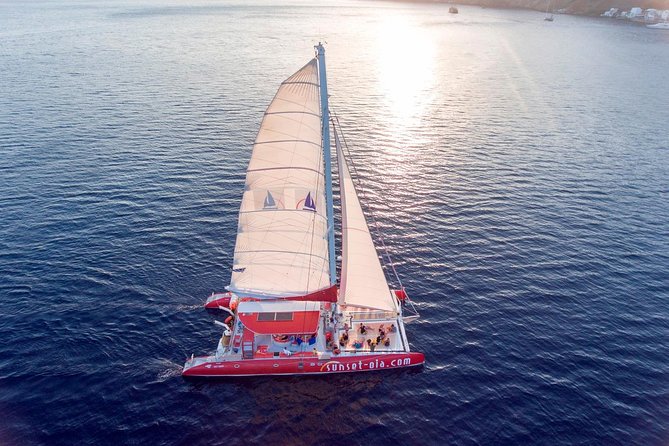 Sunset Sailing Catamaran Cruise in Santorini with BBQ and Drinks - The sunset portion near Oia